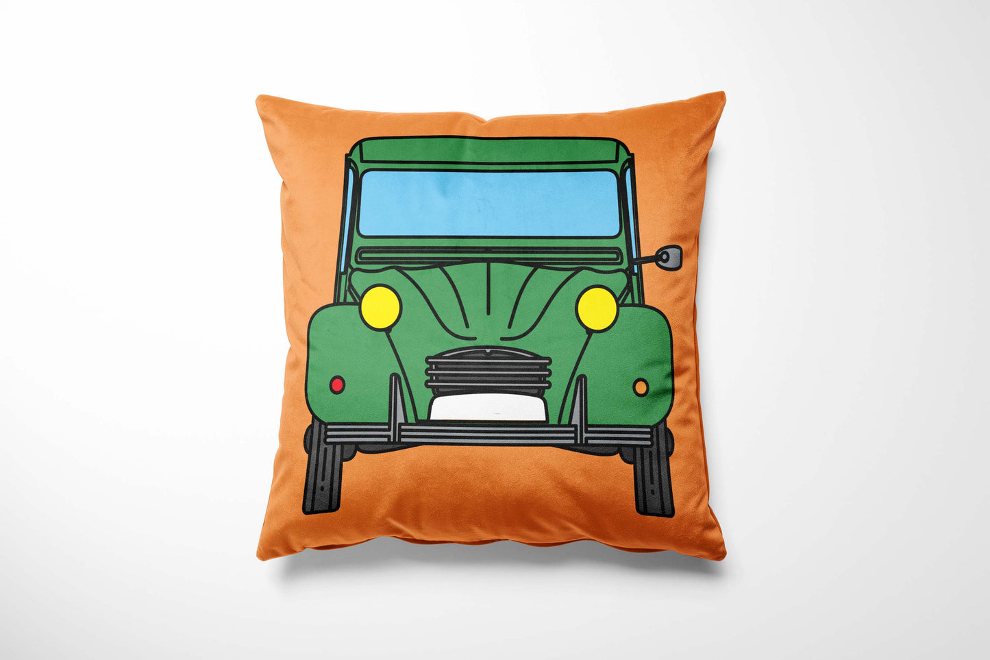 Cushion with a colourful green car design on an orange background