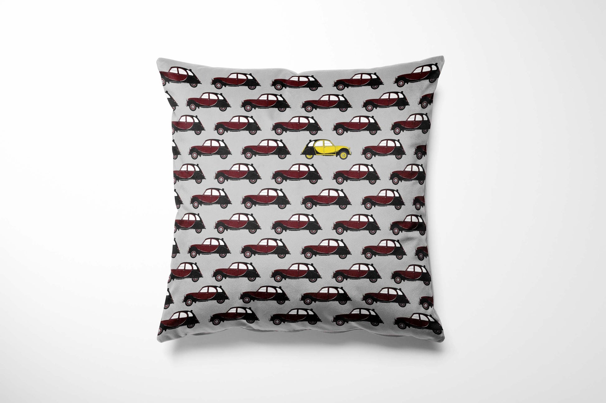Cushion with maroon Charleston pattern on a grey background